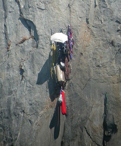 A climber at the twelfth belay on Zodiac using an umbrella for shade &...