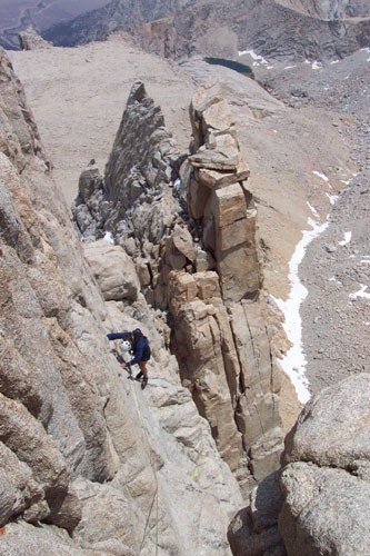 The Tower Traverse with 800 feet of exposure below Sarah's feet.