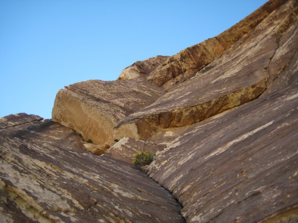 Looking up at the thin traverse left under the roof, mid-way up the ro...