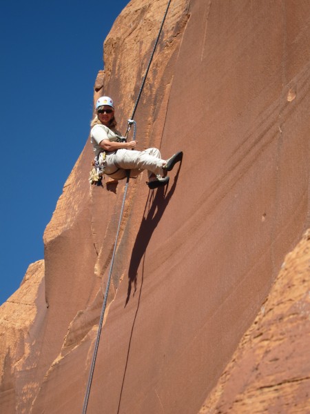 Chris rappels down the cliff