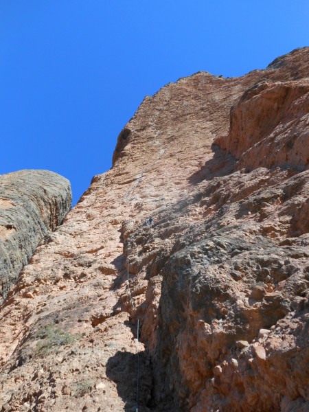 Looking up the Visor, Bob approaching the belay at the end of pitch 1 ...