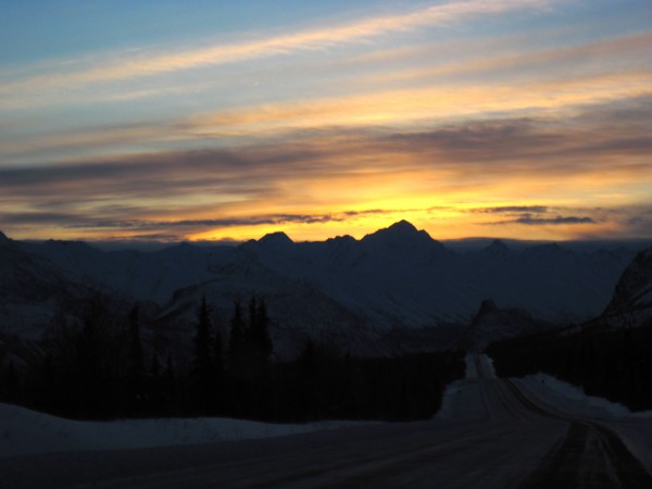 Setting sun with the road snaking downhill before us.