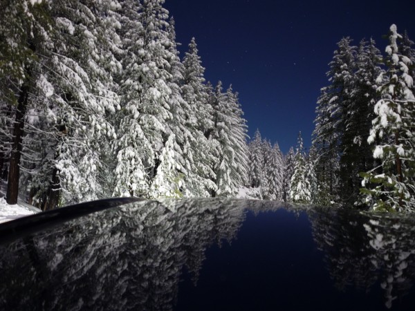 Long exposure of wintry scene approaching Crane Flat, near midnight un...