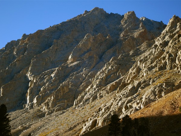 The route goes up the black chimney, hangs a left past the sunlit towe...