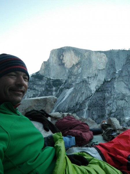 Wes enjoys the view of snow-trimmed Half Dome from Dinner Ledge as the...