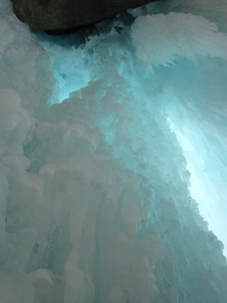 Cool ice in the cave climbing up through and past chandeliers in the d...