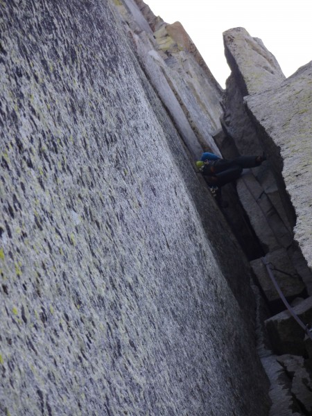 Lukasz chimneying through the 5.7 section. Placed the backpack on the ...