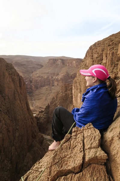 Sun shielding myself at a belay ledge above the Gorge on a thousand fo...