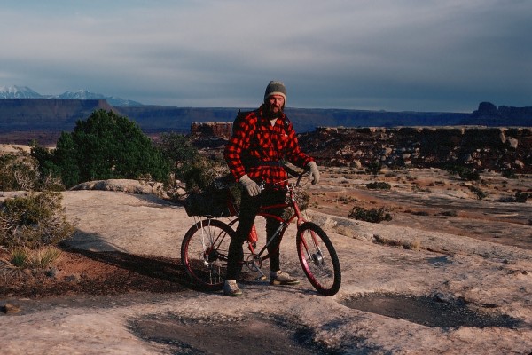 Steve and his bike on the Permian White Rim Sandstone Formation.  Not ...