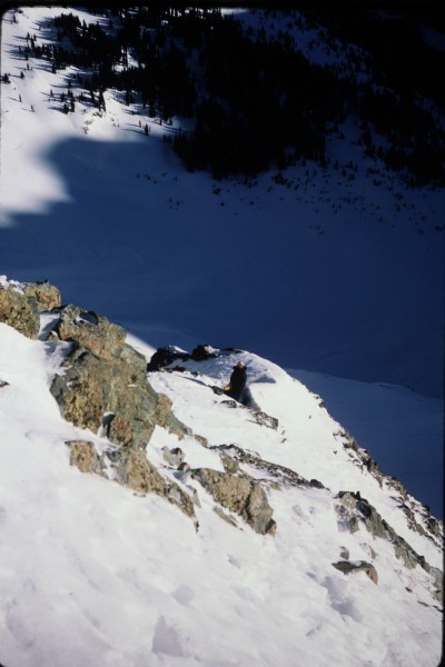 Looking down at John at the bivy ledge as I head towards the central c...