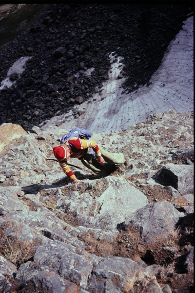 Charlie scrambling up the ledges on the lower angle rock near the base...