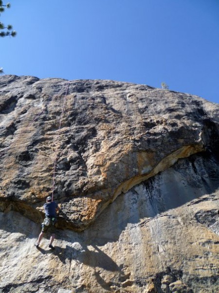 Ezra tr'ing a 5.10+ on the side of Trapper