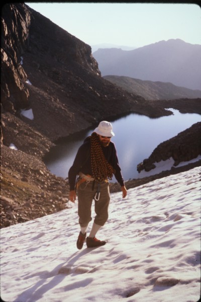 John approaching the base of Stettners Ledges across the snow field at...