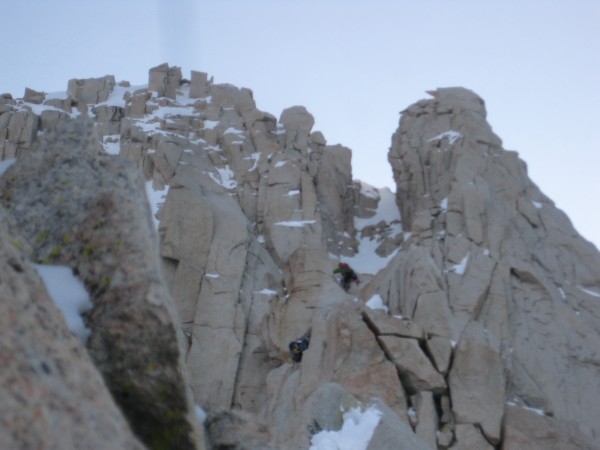 Kevin climbing with couloir towering above