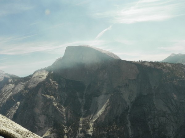 Half dome wreathed in smoke from fires.