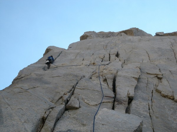 Climbing toward a remarkable ledge at the end of pitch five