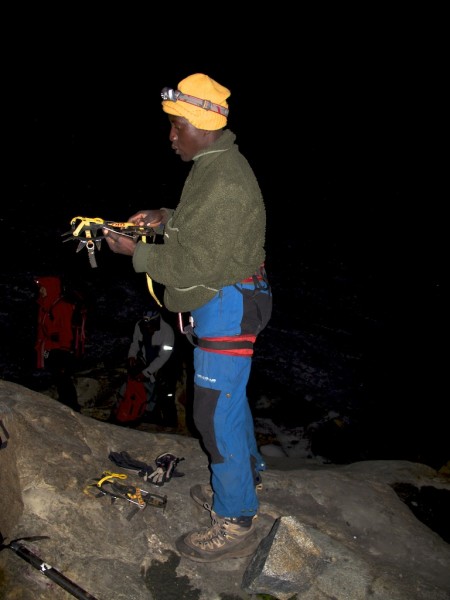 Rauben gets his crampons ready at the edge of the Stanley Plateau.