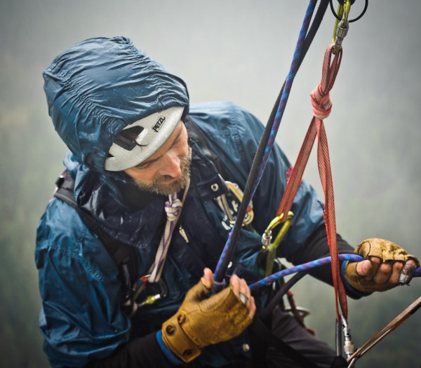 Stefan Jacobsen rappelling from the stovelegs in stormy weather on Mon...